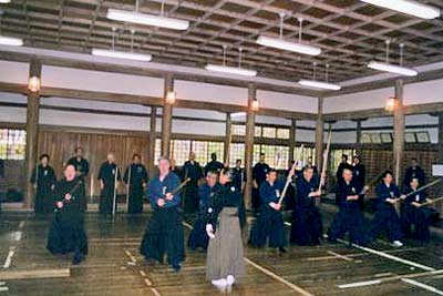 Showing jodo technique at the shrine. Kaminoda Sensei is in the foreground. Photo courtesy of T. Kaminoda.